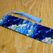 a blue and white tie laying on top of a wooden table