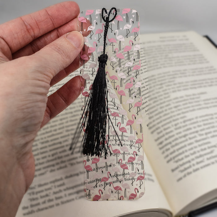 a person holding an open book with a tassel