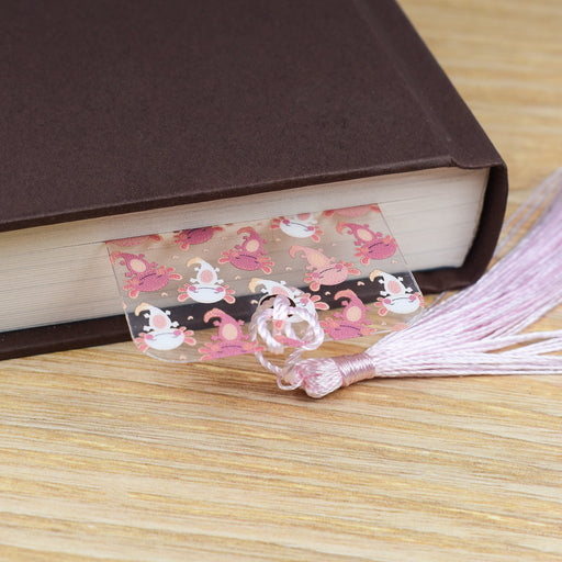 a close up of a book on a table with a tassel