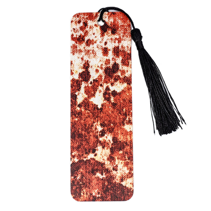 an orange and white bookmark with a tassel