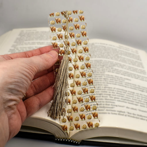 a person holding a book with a bookmark on it