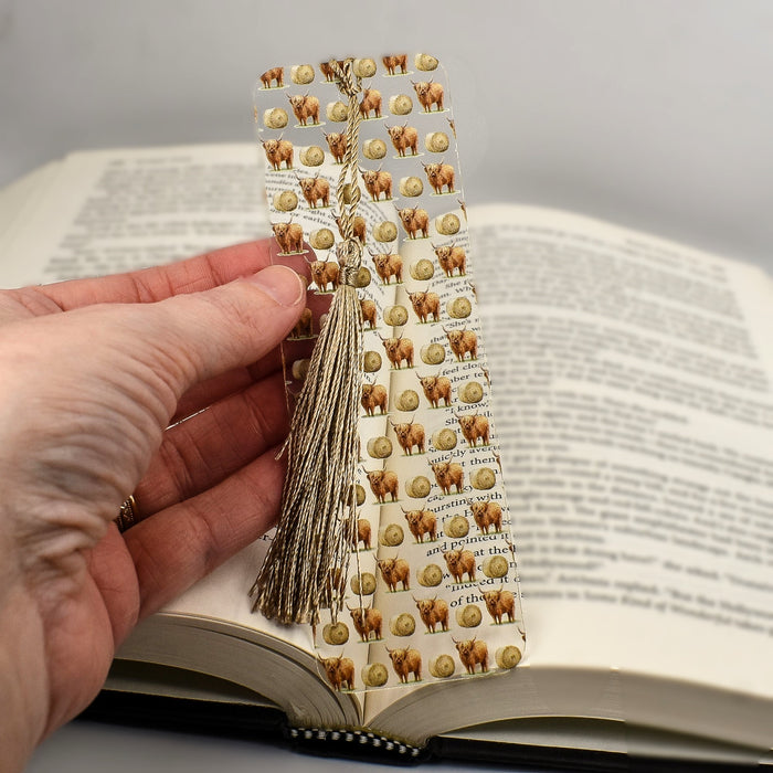 a person holding a book with a bookmark on it