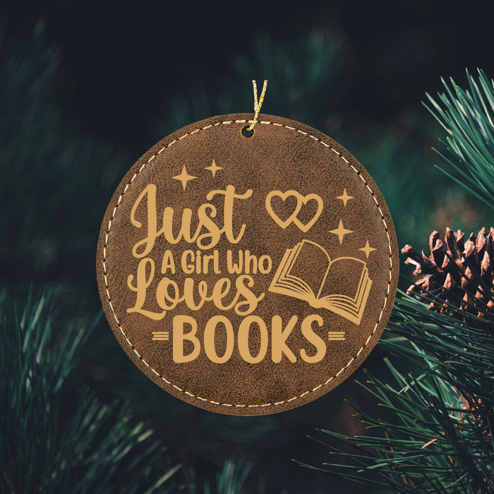 a book ornament hanging from a christmas tree