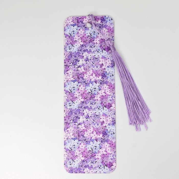 a phone case with a flower pattern and a tassel