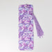 a phone case with a flower pattern and a tassel