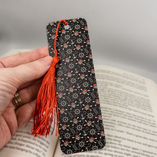 a person is holding a book with a tassel on it