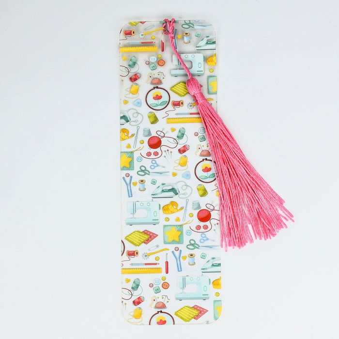 a bookmark with a pink tassel on top of it